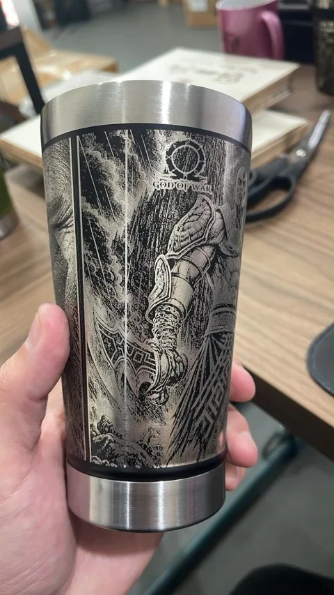 Copo térmico preto com ilustração detalhada gravada em toda a volta
